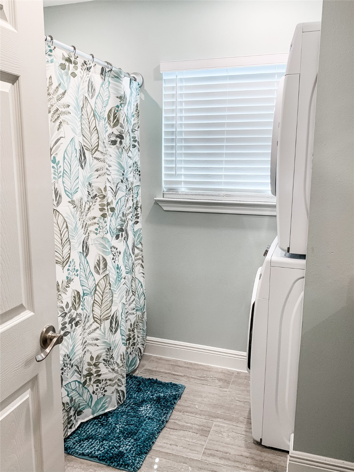 246 Seagull Road Sargent, TX 77414 - Photo 13 of 25 a view of a bathroom with a window and a shower curtain