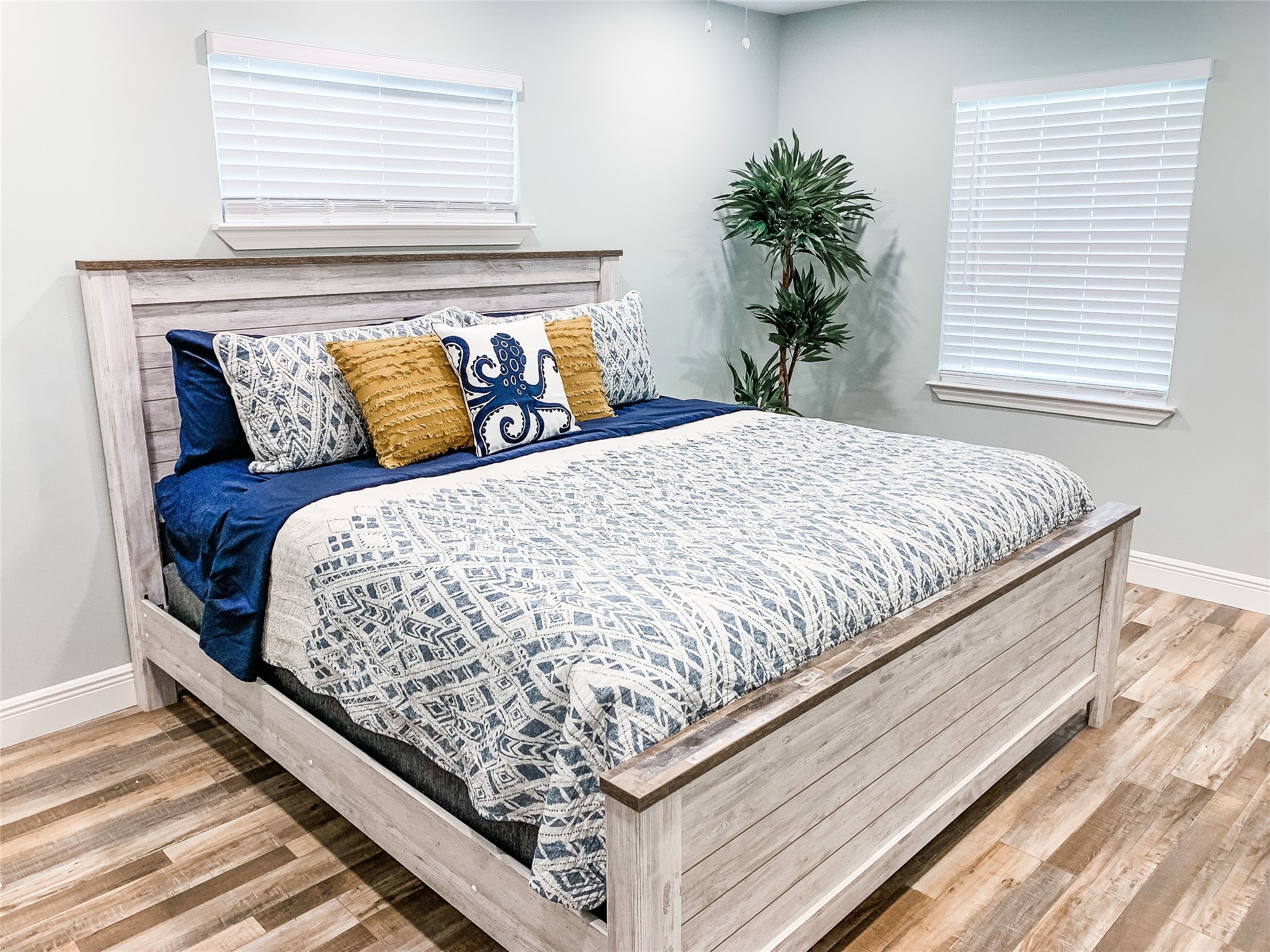 246 Seagull Road Sargent, TX 77414 - Photo 14 of 25 a bed sitting in a bedroom next to a window with potted plants