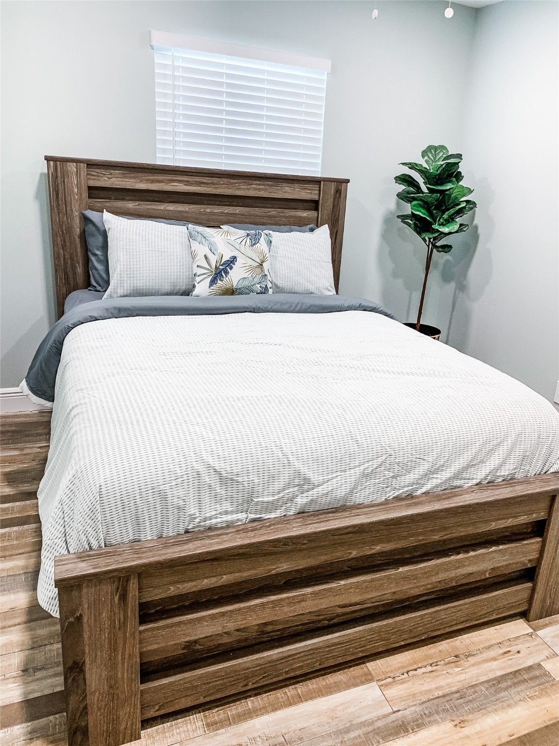 246 Seagull Road Sargent, TX 77414 - Photo 17 of 25 a bedroom with a bed and a potted plant