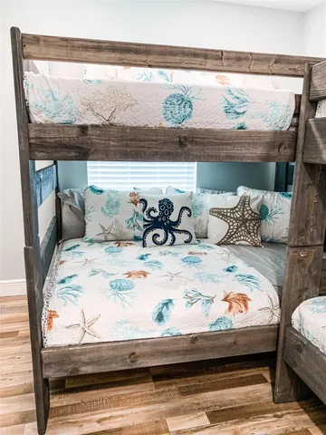 a bedroom with a bed and large window