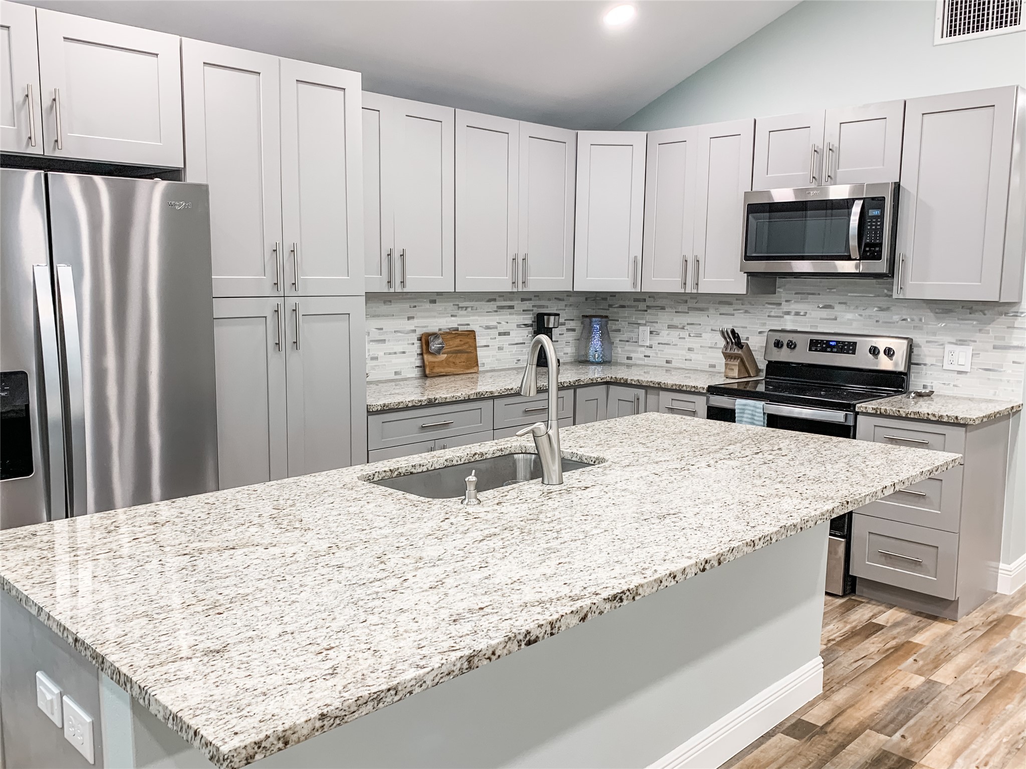 246 Seagull Road Sargent, TX 77414 - Photo 2 of 25 a kitchen with stainless steel appliances granite countertop a sink stove and refrigerator