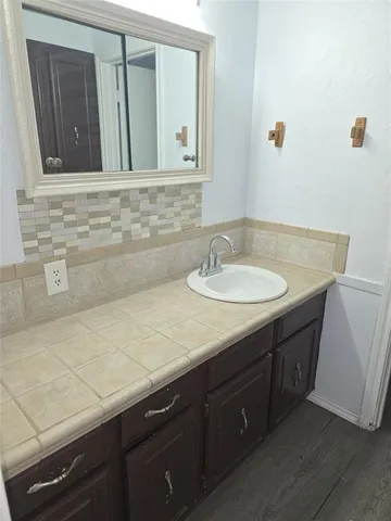 a bathroom with a sink and a mirror