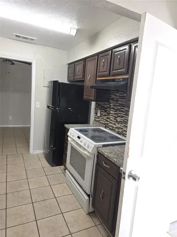 a kitchen with a stove and a refrigerator