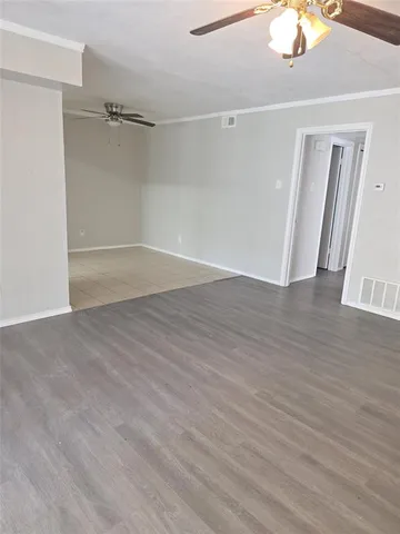 a view of a room with wooden floor