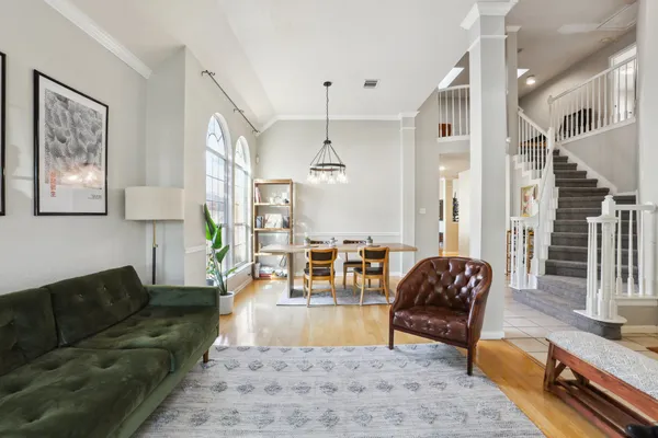 a living room with furniture and wooden floor