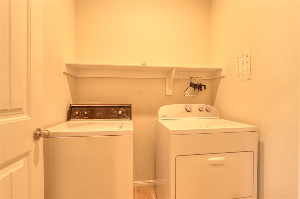 744 Walls Boulevard Crowley, TX 76036 - Photo 24 of 28 a utility room with dryer and washer