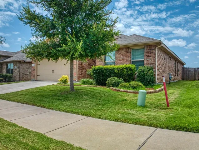 a front view of house with a garden