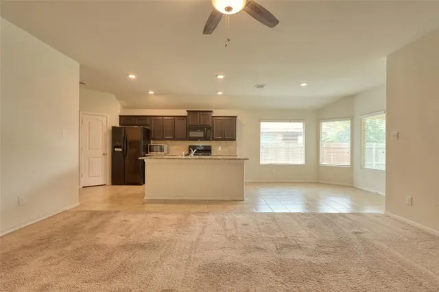 a view of a kitchen with a sink and a window