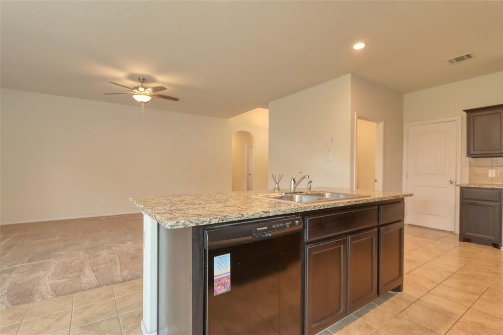 744 Walls Boulevard Crowley, TX 76036 - Photo 8 of 28 a kitchen with a sink a counter space appliances and a window