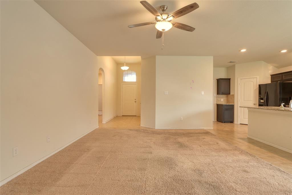 744 Walls Boulevard Crowley, TX 76036 - Photo 9 of 28 a view of a kitchen with a sink and a refrigerator