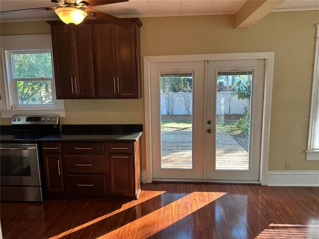 a kitchen with wooden cabinets and a wooden floor