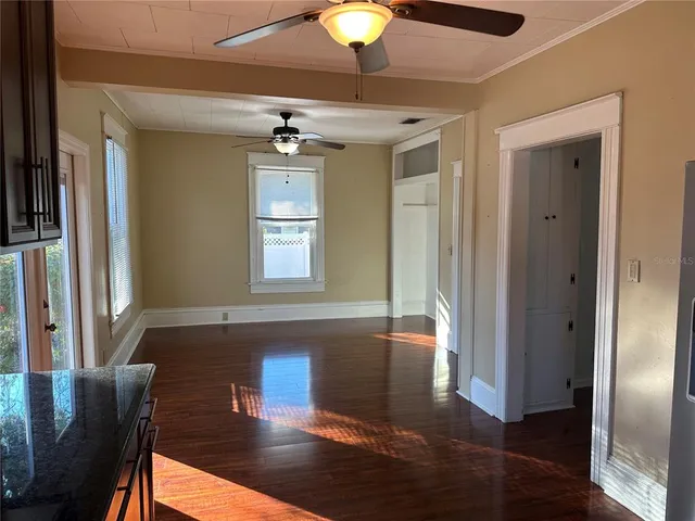 a view of a livingroom with furniture wooden floor and window