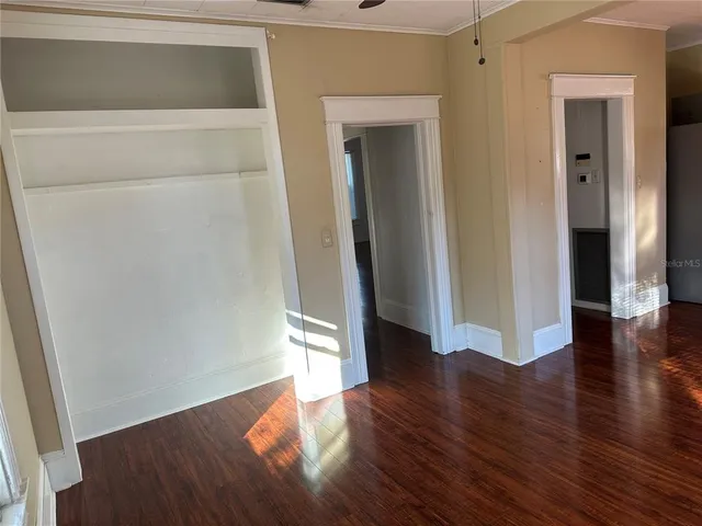 a view of a hallway with wooden floor
