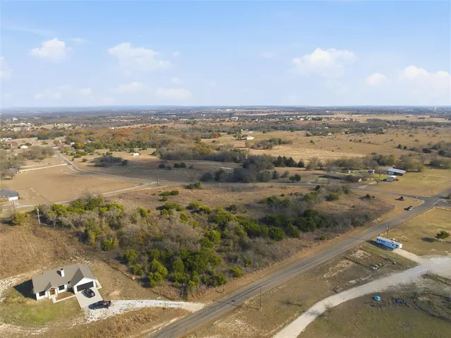 a view of a field of grass and trees