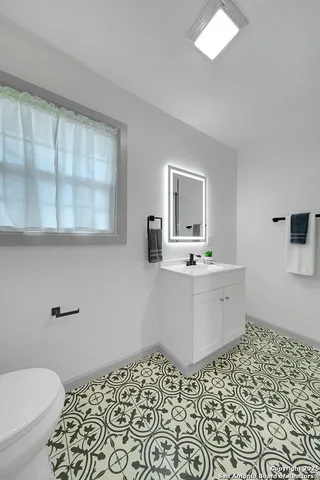 a bathroom with a sink a mirror and a toilet