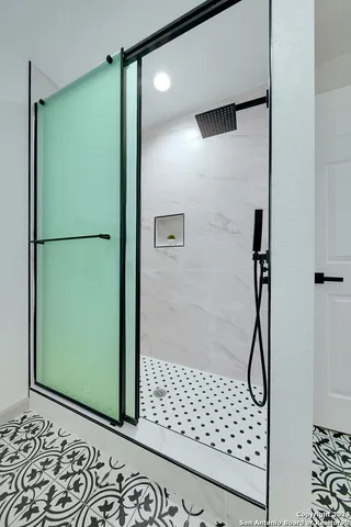 a bathroom with a shower and a mirror