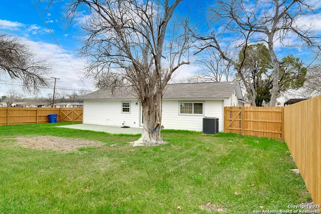 a front view of house with yard and trees