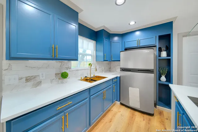 a kitchen with refrigerator and cabinets