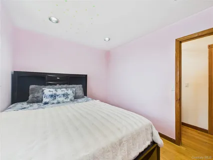 a bedroom with a bed and wall painting