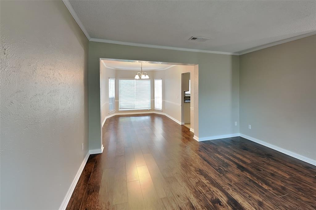 604 Ashby Place Allen, TX 75002 - Photo 3 of 21 wooden floor in an empty room with a window