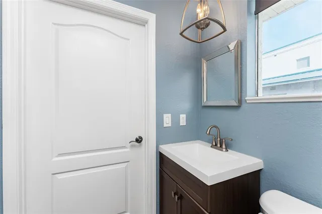 an aerial view of a houses with ocean view in back