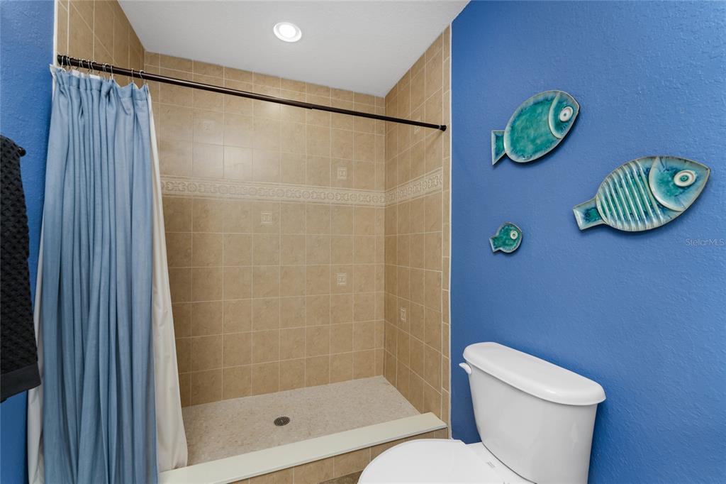 8013 Bay Point Drive Englewood, FL 34224 - Photo 59 of 82 a bathroom with a toilet and a shower