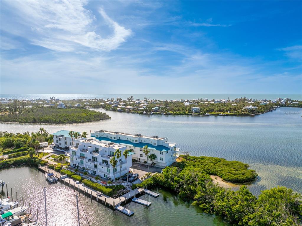 8013 Bay Point Drive Englewood, FL 34224 - Photo 69 of 82 an aerial view of a city with lake view and houses in the back