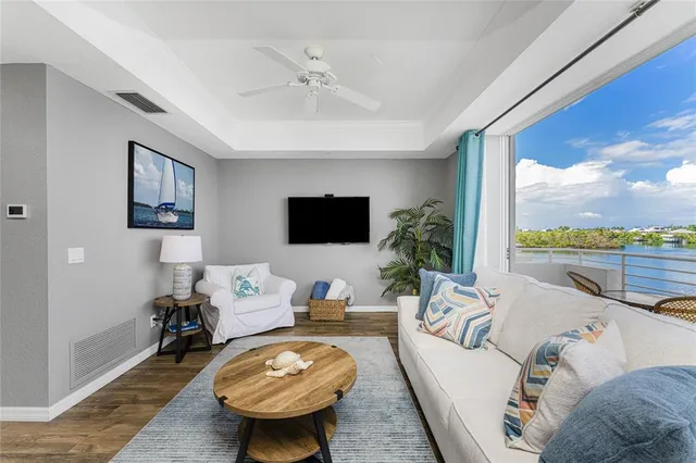 a kitchen with a refrigerator a stove top oven a sink dishwasher and white cabinets with wooden floor