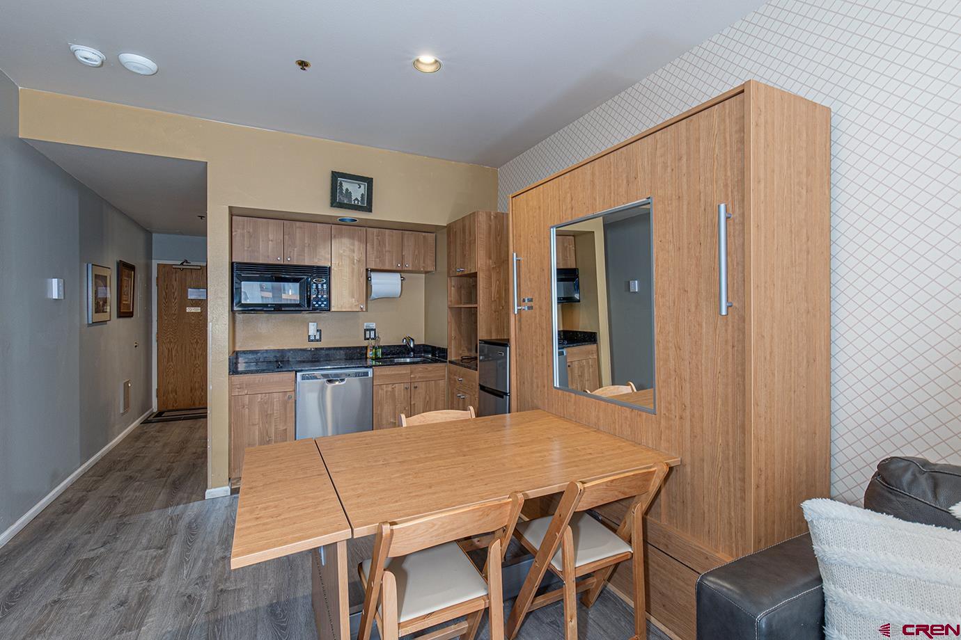 71 Needles Way, Unit 343 Durango, CO 81301 - Photo 4 of 18 a open kitchen with a table and chairs in it