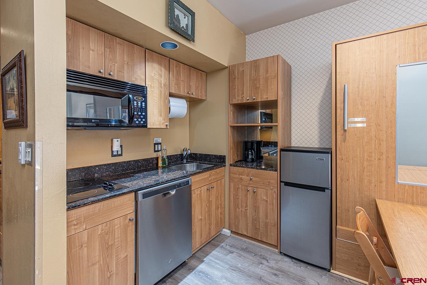 71 Needles Way, Unit 343 Durango, CO 81301 - Photo 5 of 18 a kitchen with stainless steel appliances granite countertop a refrigerator and a stove top oven