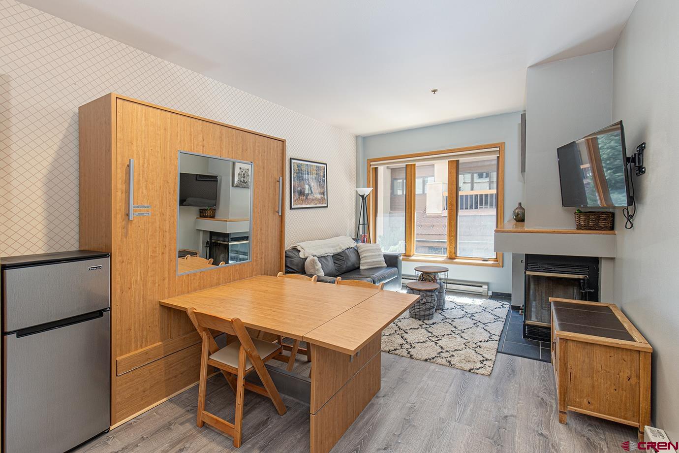 71 Needles Way, Unit 343 Durango, CO 81301 - Photo 6 of 18 a view of a dining room with furniture window and wooden floor