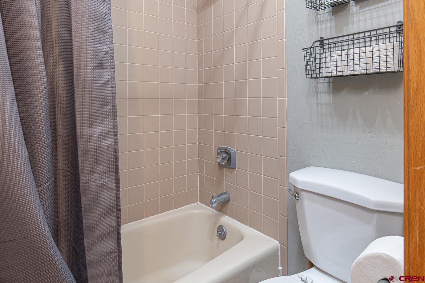 71 Needles Way, Unit 343 Durango, CO 81301 - Photo 10 of 18 a white bath tub sitting next to a toilet