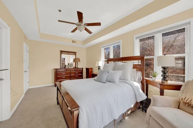 a bedroom with a bed and ceiling fan