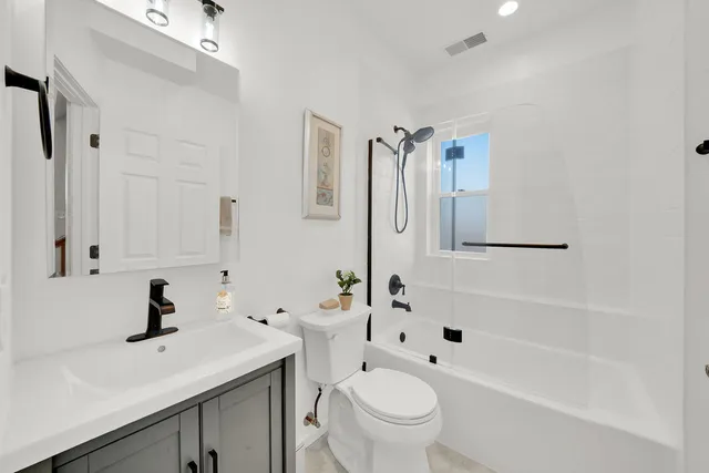 a white toilet sitting next to a bathroom sink