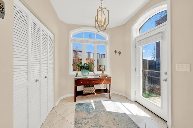 a view of hall way with furniture and chandelier