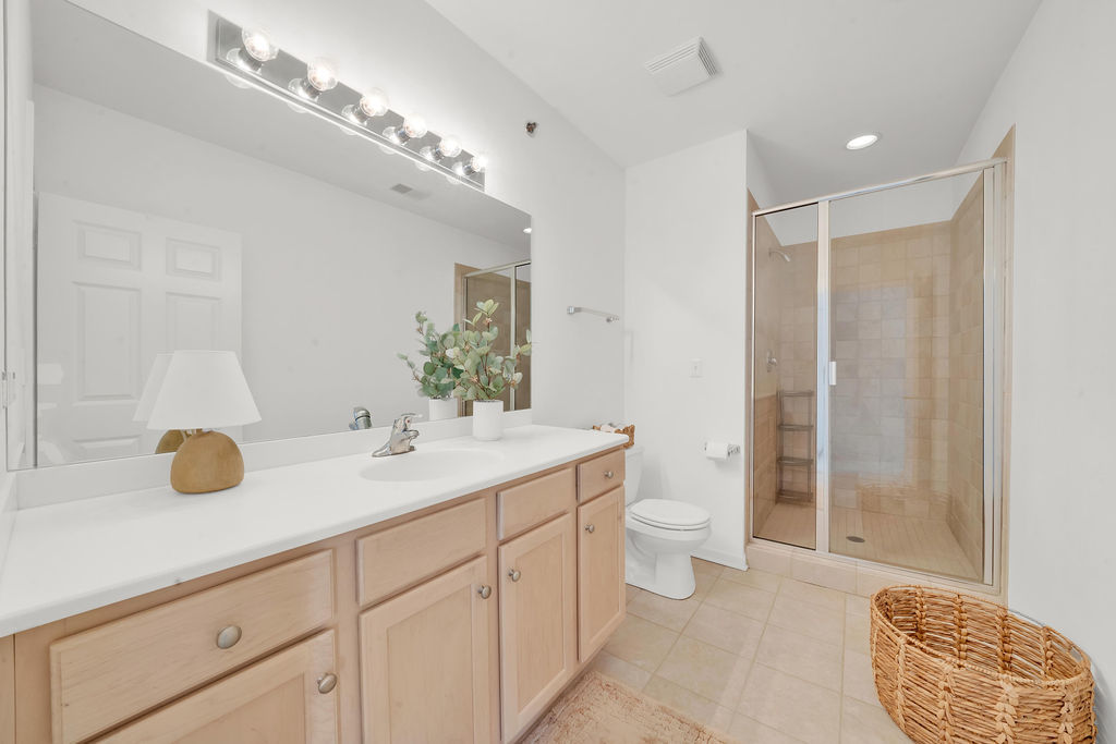 324 East 17th Street Chicago, IL 60616 - Photo 22 of 25 a bathroom with a granite countertop sink a toilet and a mirror
