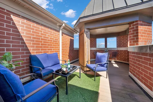 a view of a patio with table and chairs
