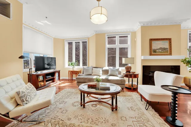 a living room with furniture a flat screen tv and a fireplace
