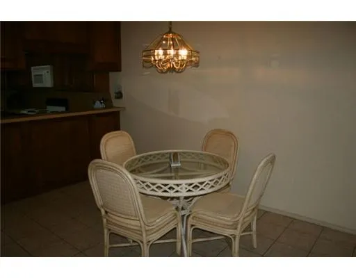 a dining room with furniture and chandelier