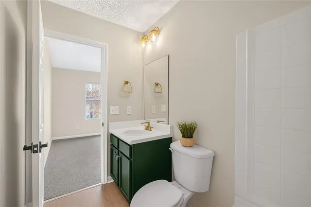 a bathroom with a toilet sink and mirror