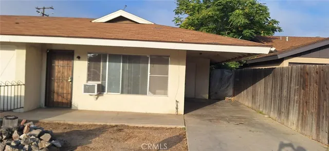 a view of a house with a wooden fence
