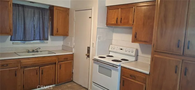 a kitchen with a stove cabinets and a refrigerator
