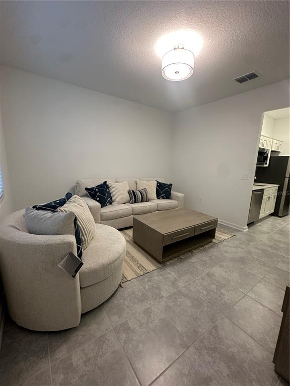 1623 Marksman Road Eagle Lake, FL 33839 - Photo 17 of 24 a living room with couches and a flat screen tv