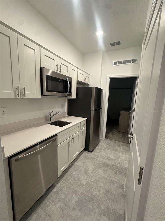 1623 Marksman Road Eagle Lake, FL 33839 - Photo 18 of 24 a kitchen with stainless steel appliances a refrigerator sink and microwave