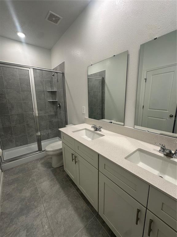 1623 Marksman Road Eagle Lake, FL 33839 - Photo 22 of 24 a bathroom with a double vanity sink mirror and shower