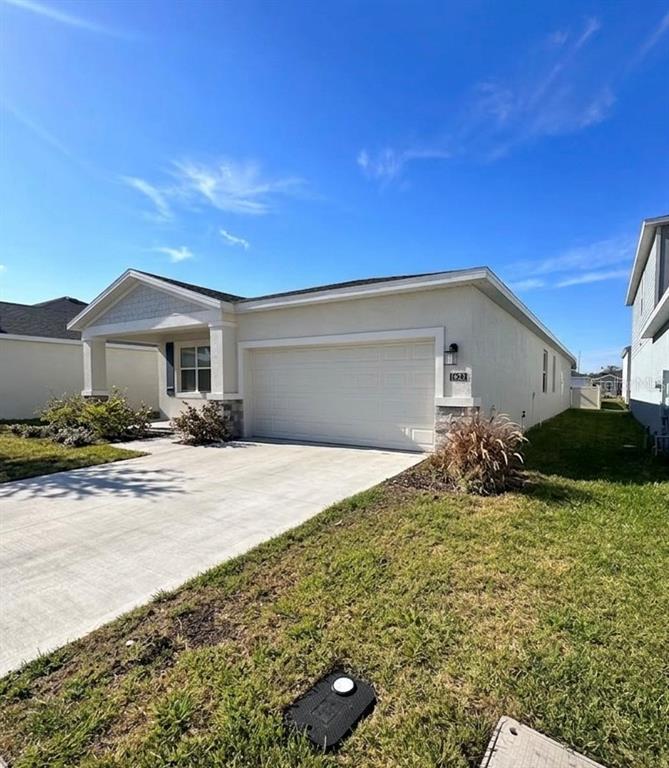 1623 Marksman Road Eagle Lake, FL 33839 - Photo 3 of 24 a front view of house with yard and trees in the background