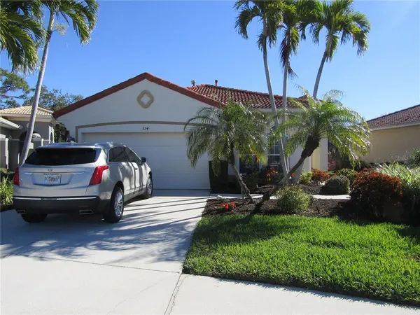 a view of a house with backyard and a tree