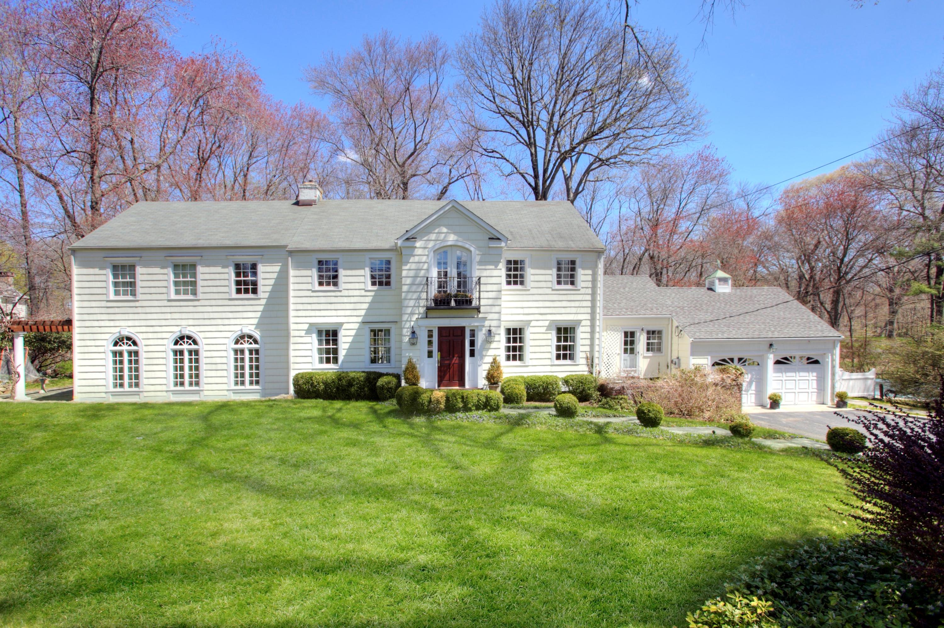 95 Pembroke Road Darien, CT 06820 - Photo 1 of 24 a front view of a house with a garden