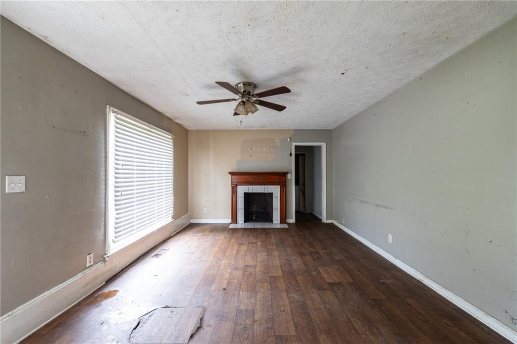 3838 Old Gordon Road Northwest Atlanta, GA 30336 - Photo 4 of 23 an empty room with fireplace and windows