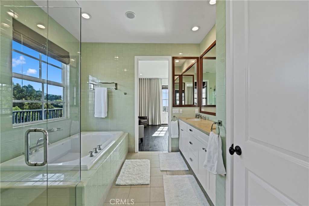 28850 Hampton Place Malibu, CA 90265 - Photo 21 of 53 a bathroom with a tub a mirror and a shower